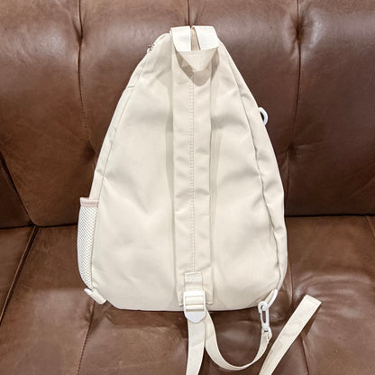 Back view of cream KOMILO crossbody sling bag showing padded back panel and adjustable strap