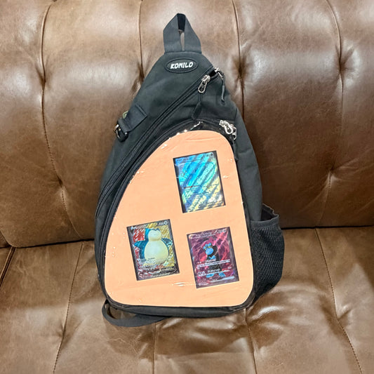 Black crossbody bag front view with peach insert and three trading cards displayed