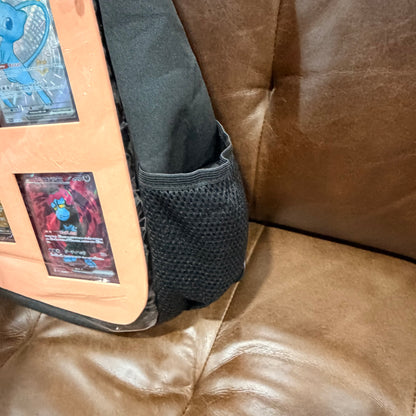 Side view showing mesh pocket on black crossbody bag with peach insert